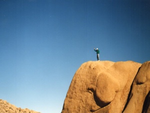 Kyle Samper atop massif rock, Joshua Tree National Monument, 1989, photo © Janice Samper